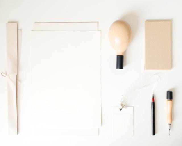 A complete calligraphy starter kit with pen, nib, ink, and paper.